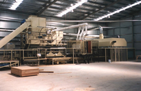 Pre-feeding and Stacking in a Machine that Converts Waste Agricultural Product into Fibre Board